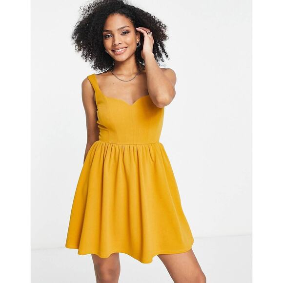 ASOS Dresses & Skirts - ASOS DESIGN strappy corset detail flippy mini dress in mustard
